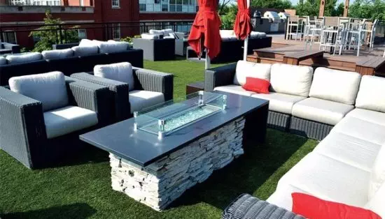 propane fire pit with couches around it
