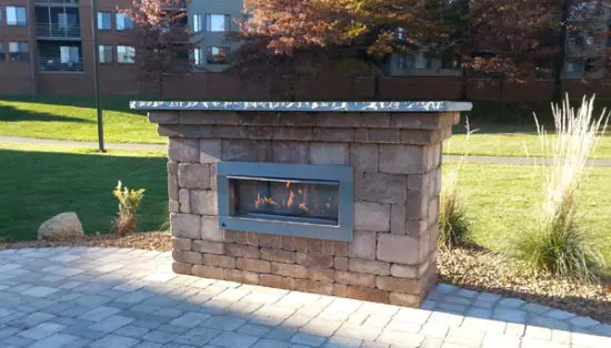outdoor fireplace next to lawn