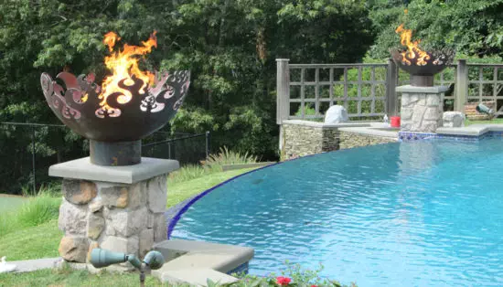 fire bowls next to pool