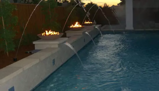 propane fire bowls next to pool